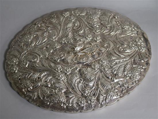 An ornate Continental white metal oval mirror with bird finial, 32.5cm.